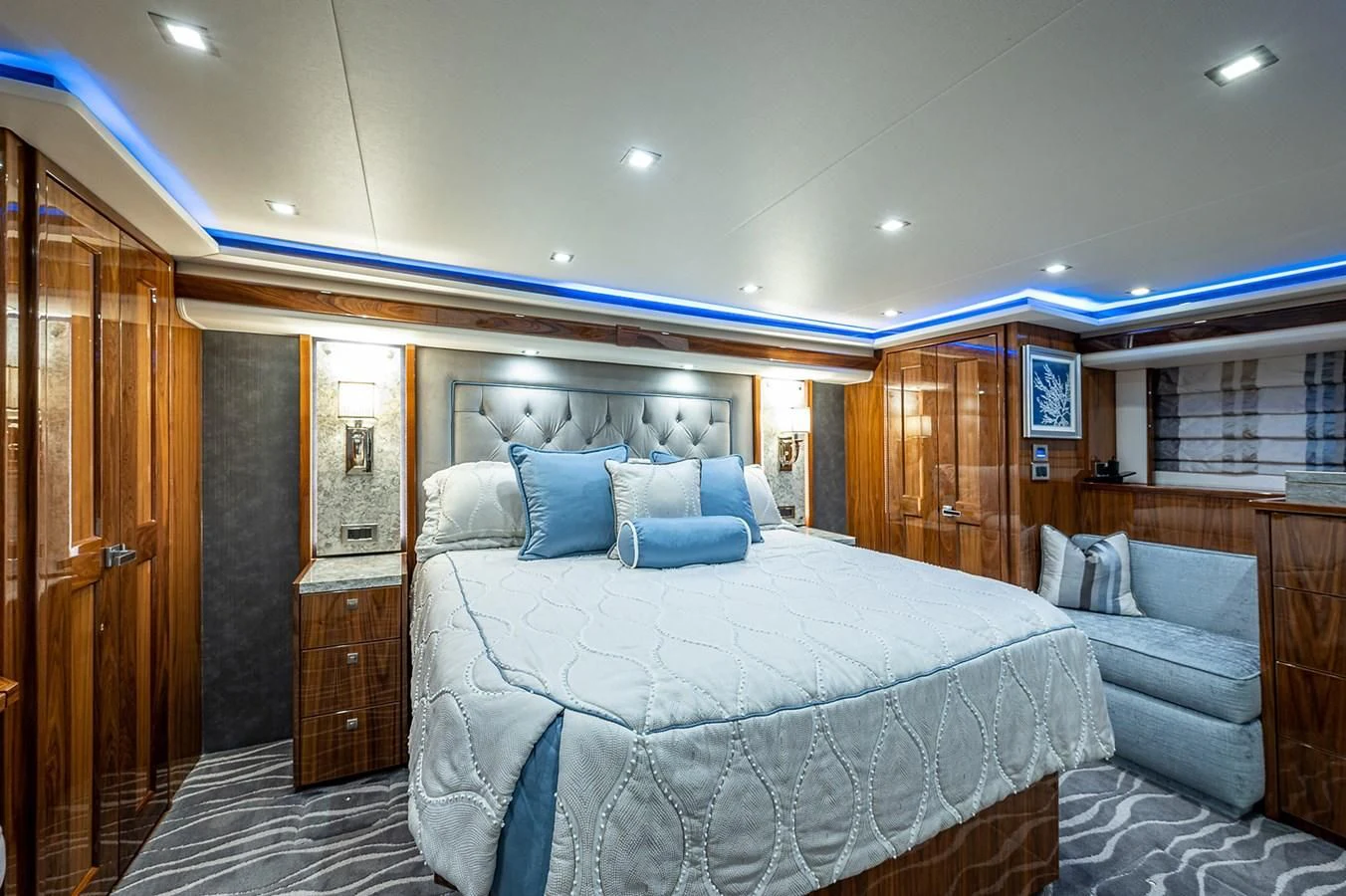 a bedroom with a bed and a wood cabinet aboard SURFBUM Yacht for Sale