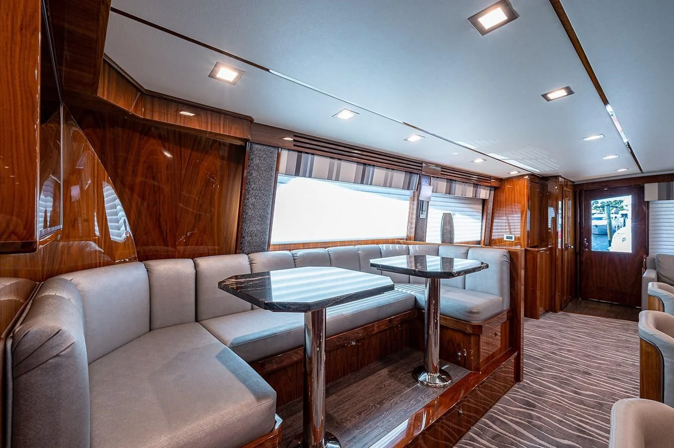 a living room with a table and chairs aboard SURFBUM Yacht for Sale