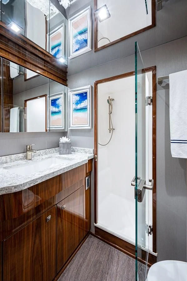 a bathroom with a sink and a mirror aboard SURFBUM Yacht for Sale