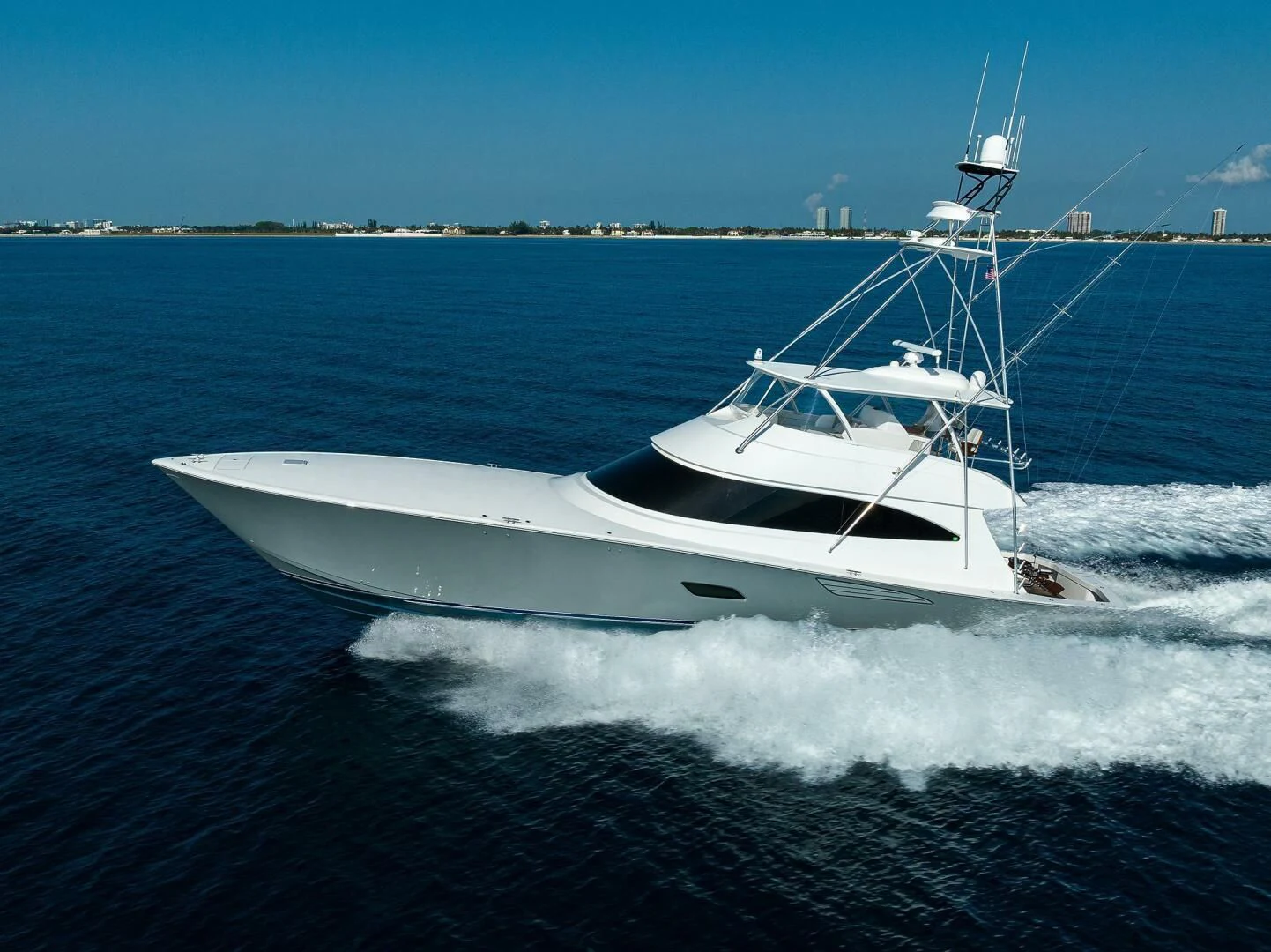 a white boat on water aboard SURFBUM Yacht for Sale
