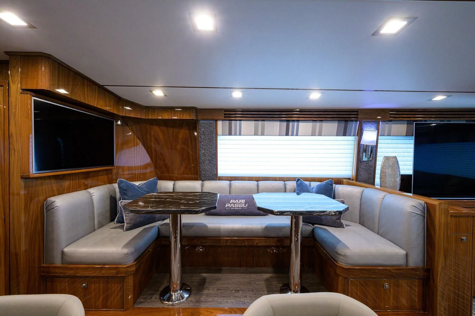 a living room with a tv and a table aboard SURFBUM Yacht for Sale