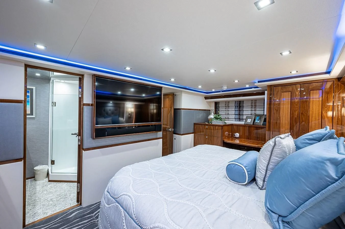 a bedroom with a bed and a television aboard SURFBUM Yacht for Sale