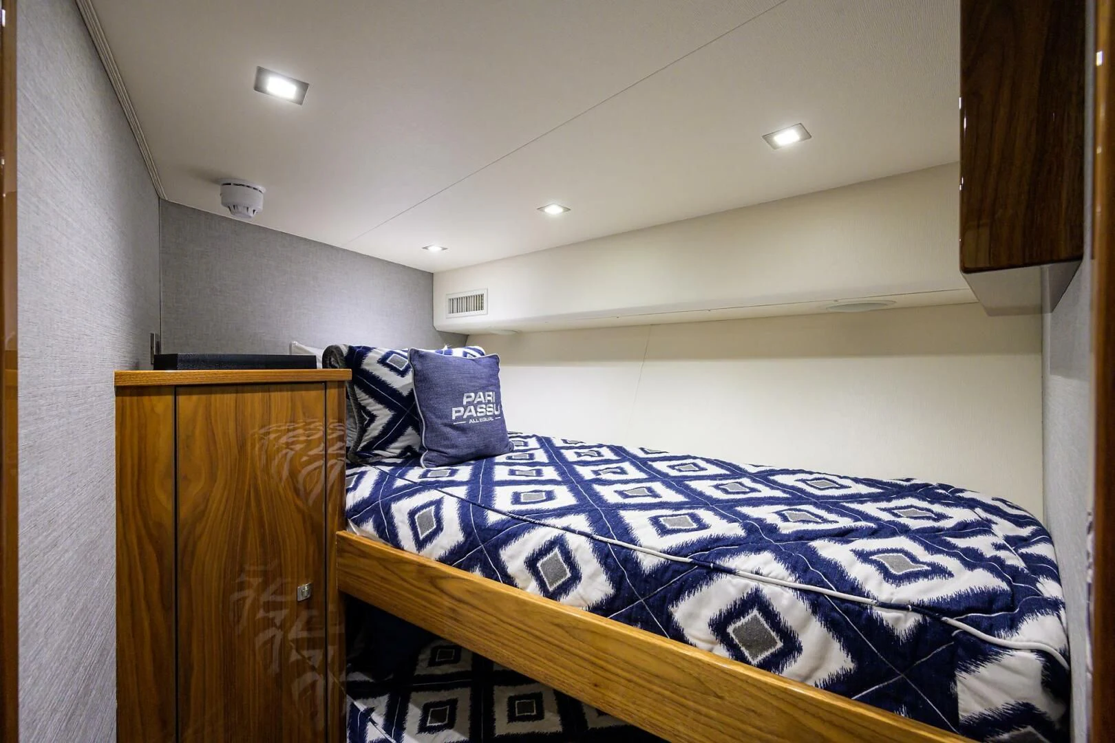 a bed with blue sheets aboard SURFBUM Yacht for Sale