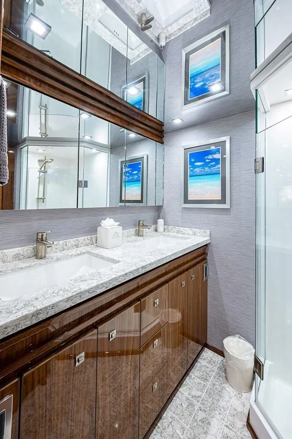 a bathroom with a large mirror aboard SURFBUM Yacht for Sale