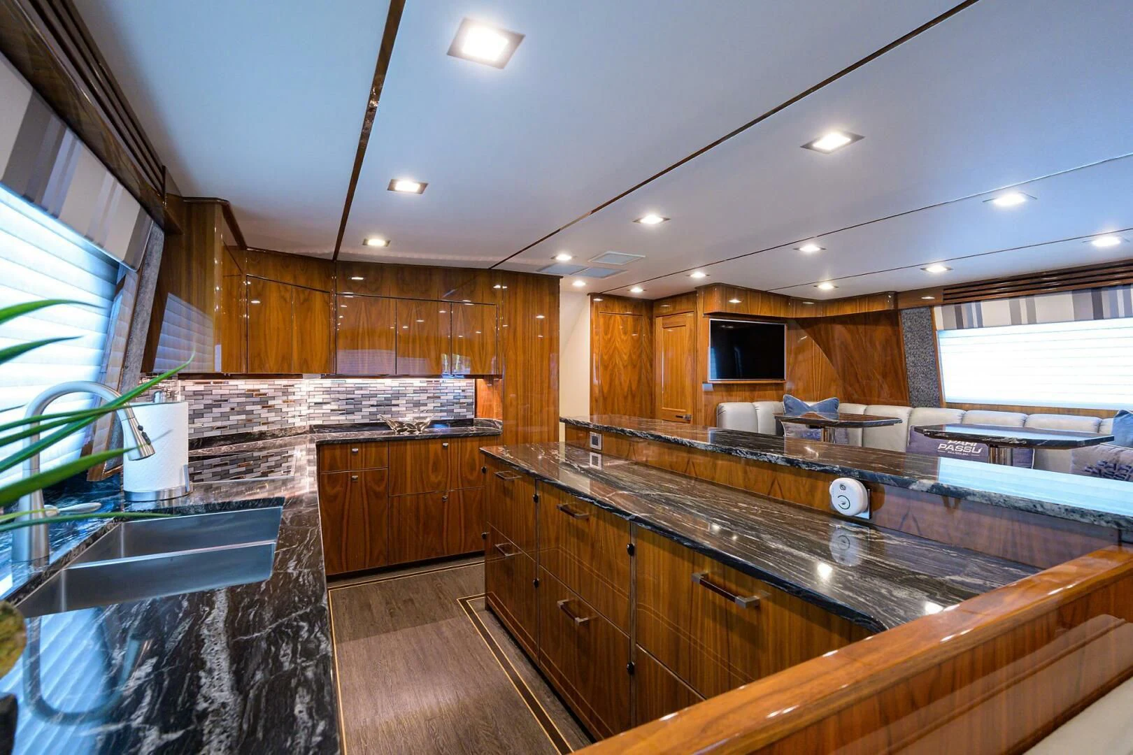 a large kitchen with wooden cabinets aboard SURFBUM Yacht for Sale