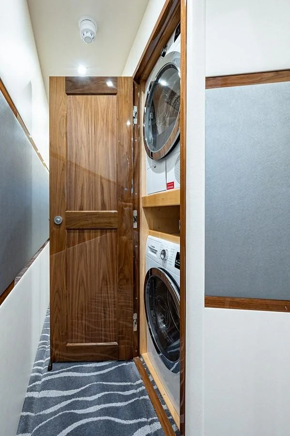 a closet with a washing machine aboard SURFBUM Yacht for Sale