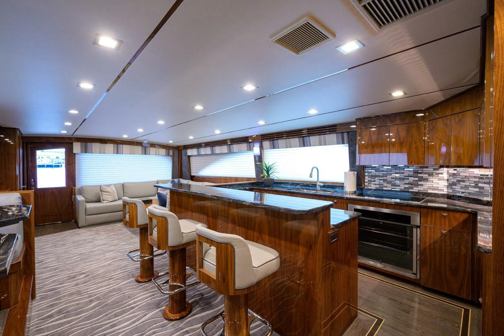 a kitchen with a bar and a table aboard SURFBUM Yacht for Sale