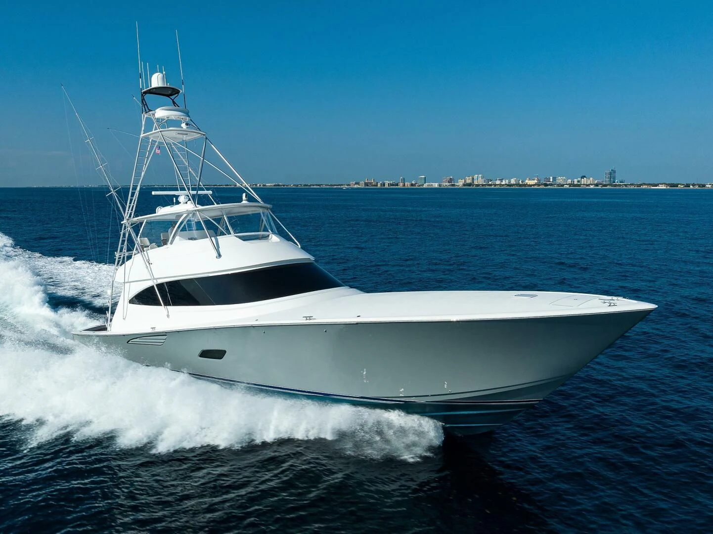a white boat on the water aboard SURFBUM Yacht for Sale