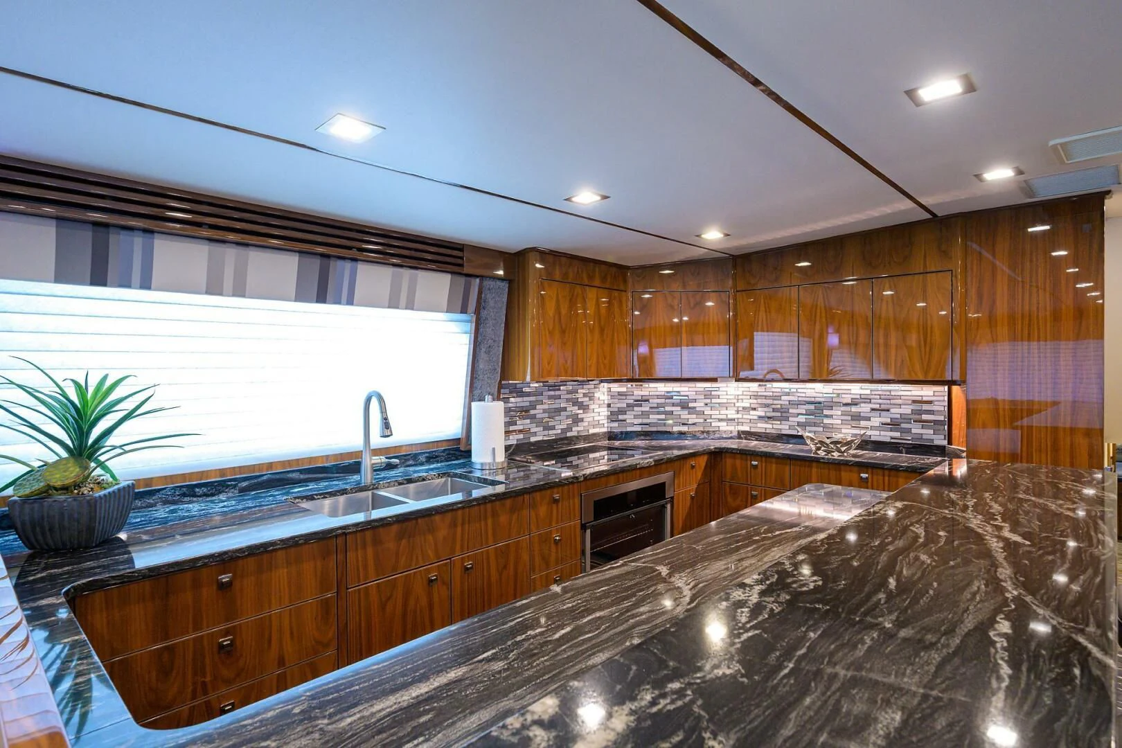 a kitchen with wooden cabinets aboard SURFBUM Yacht for Sale