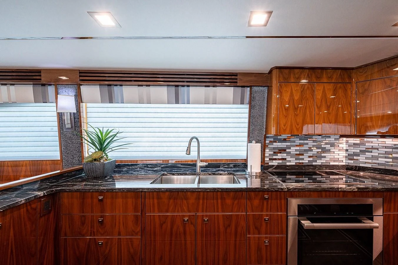 a kitchen with wooden cabinets aboard SURFBUM Yacht for Sale