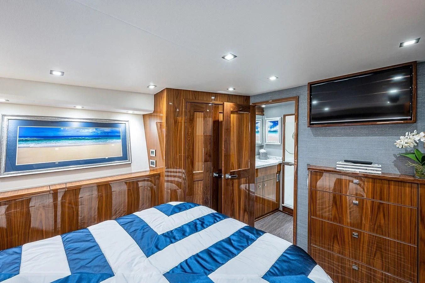 a bedroom with a tv and a dresser aboard SURFBUM Yacht for Sale