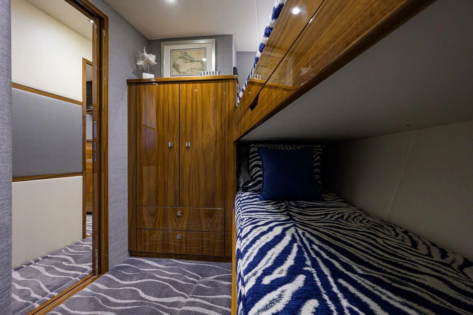 a bed with a blue and white striped comforter aboard SURFBUM Yacht for Sale