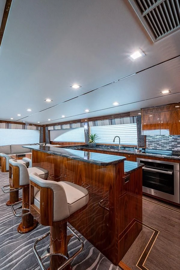 a kitchen with a bar and a bar aboard SURFBUM Yacht for Sale