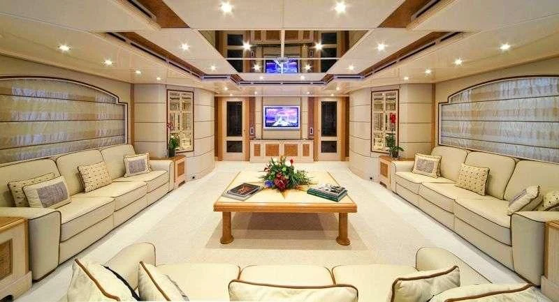 a living room with a couch and a table aboard SENSATION Yacht for Sale