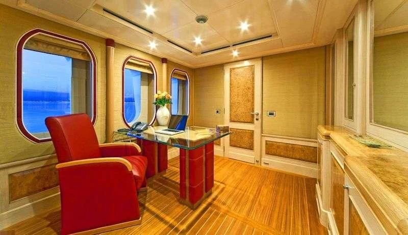 a room with a table and chairs aboard SENSATION Yacht for Sale