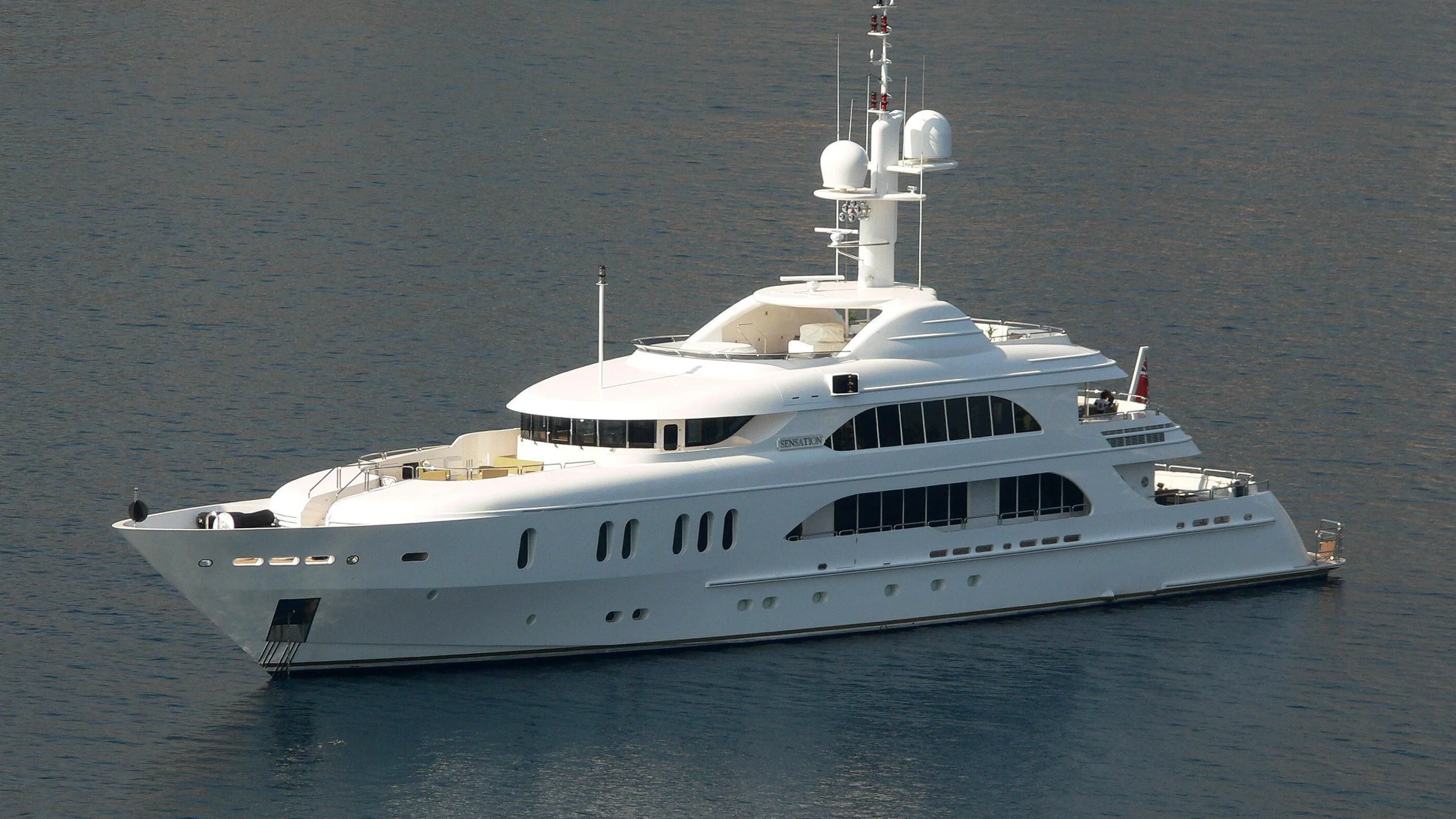 a white yacht in the water aboard SENSATION Yacht for Sale