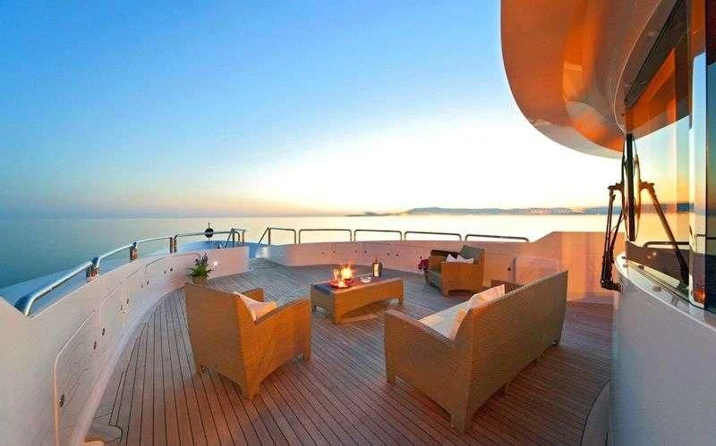 a large orange and white tent overlooking a beach aboard SENSATION Yacht for Sale