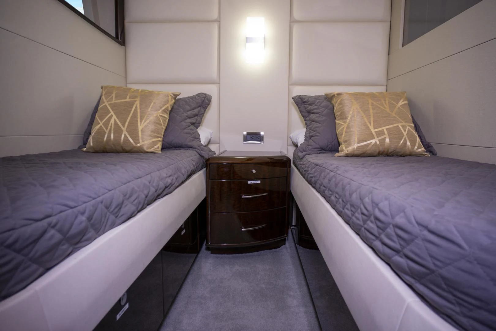 a room with a bed and a night stand aboard SALACIA Yacht for Sale
