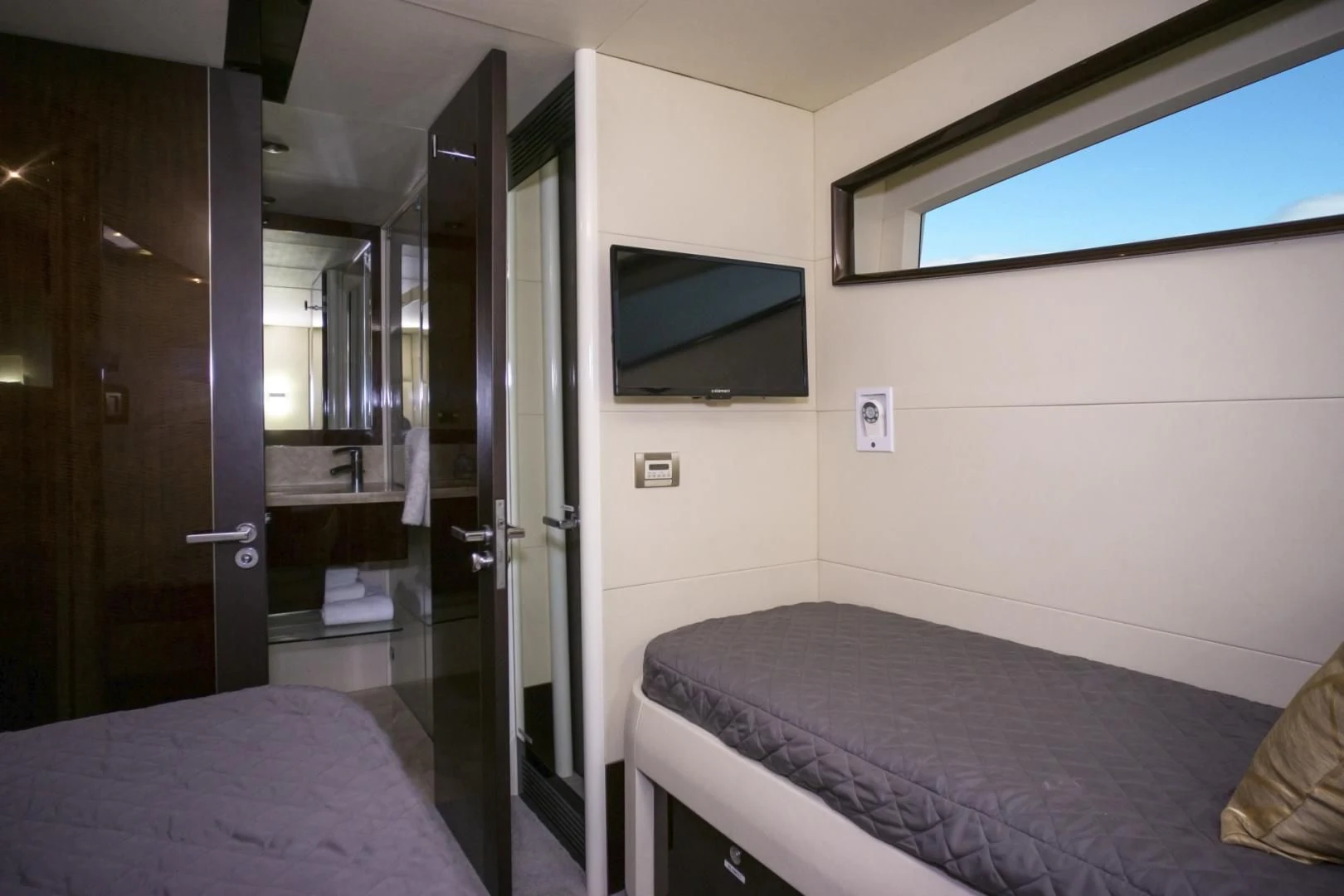 a bedroom with a bed and a television aboard SALACIA Yacht for Sale