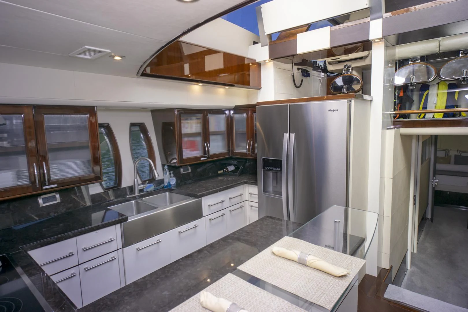 a kitchen with a stainless steel refrigerator aboard SALACIA Yacht for Sale
