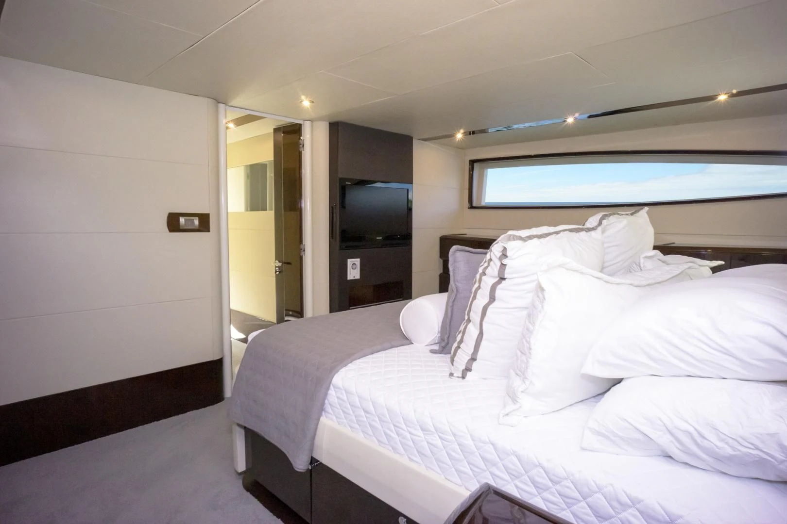 a room with a bed and a television aboard SALACIA Yacht for Sale