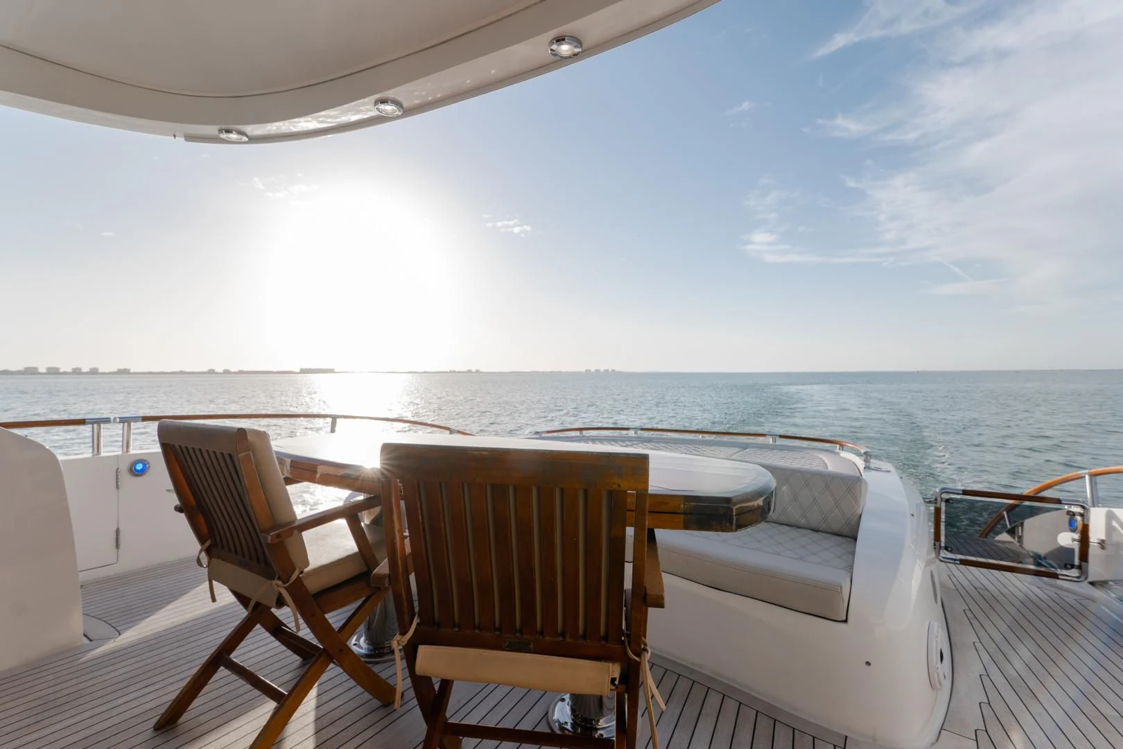 a deck with chairs and a body of water in the background aboard SALACIA Yacht for Sale