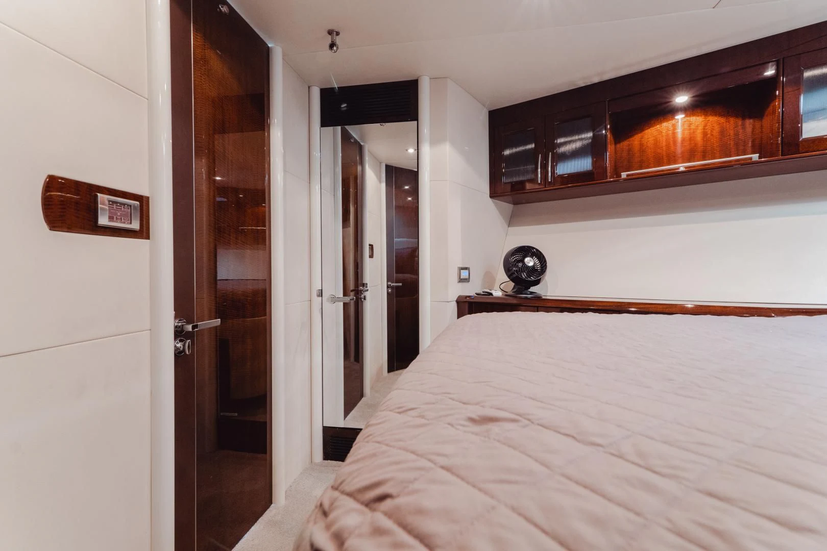 a bedroom with a bed and cabinets aboard SALACIA Yacht for Sale
