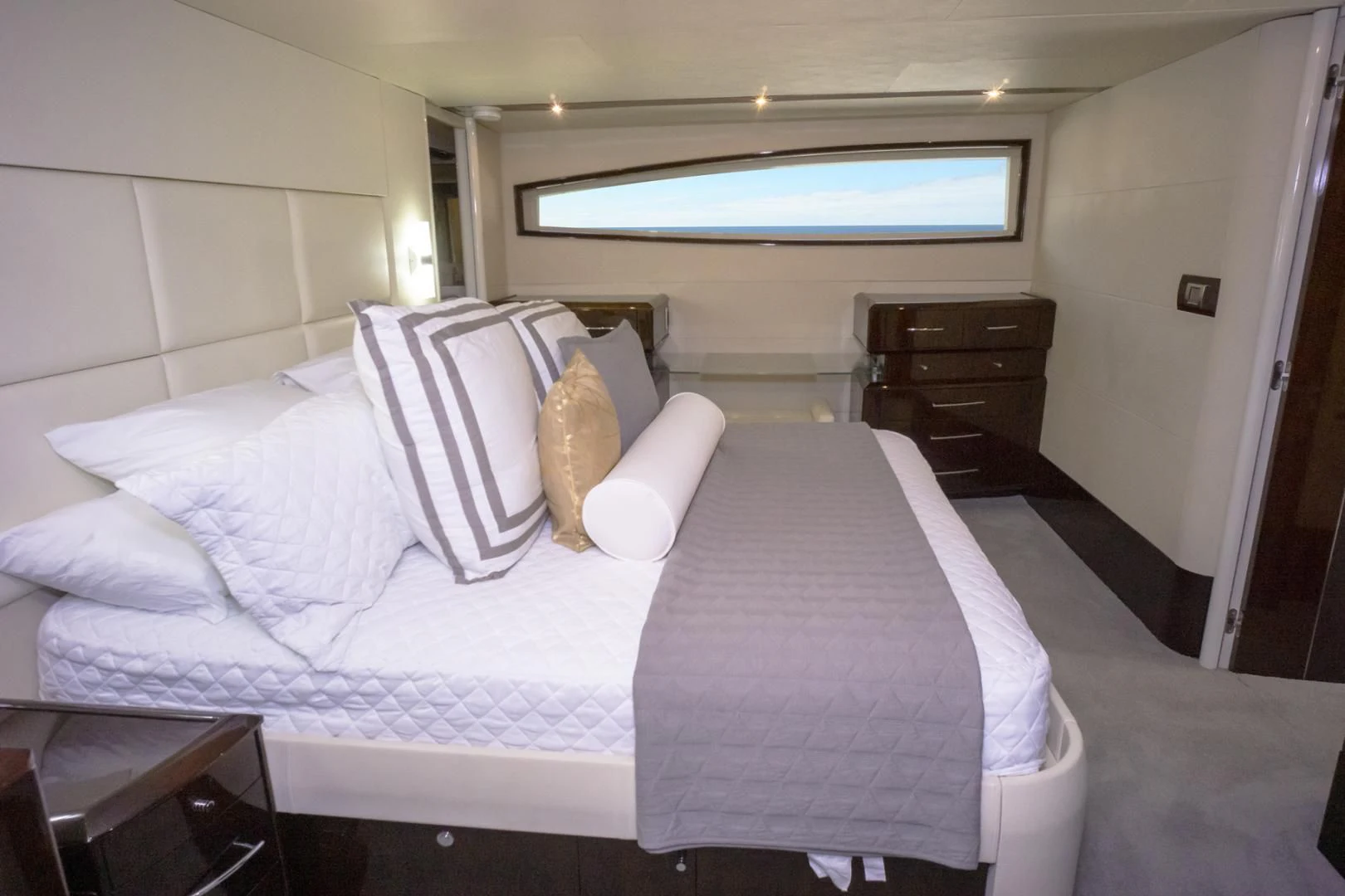 a bed with white sheets and pillows aboard SALACIA Yacht for Sale