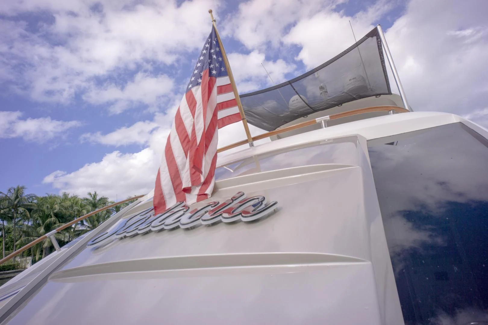 a white car with a flag on it aboard SALACIA Yacht for Sale