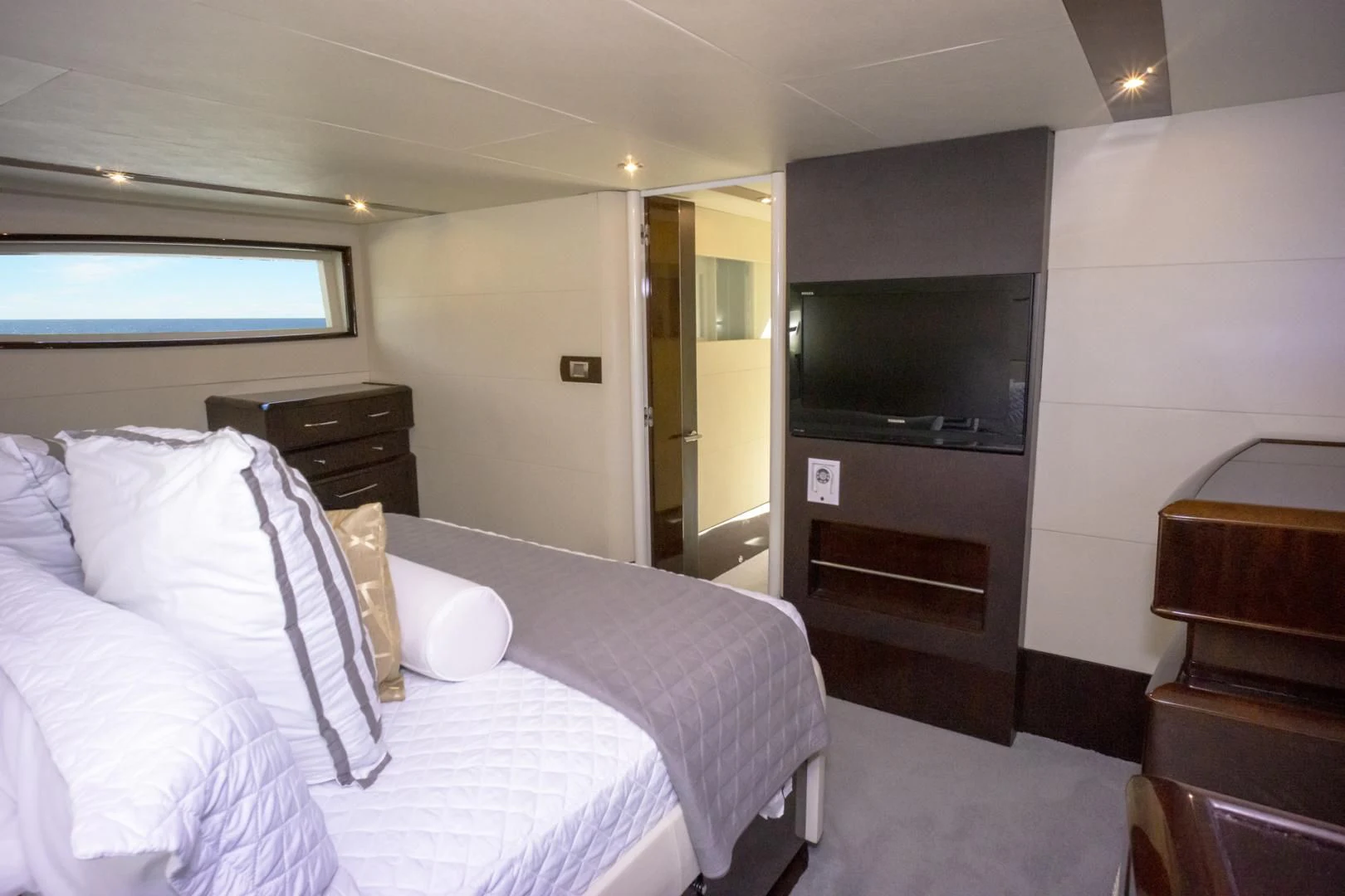 a hotel room with a bed and tv aboard SALACIA Yacht for Sale