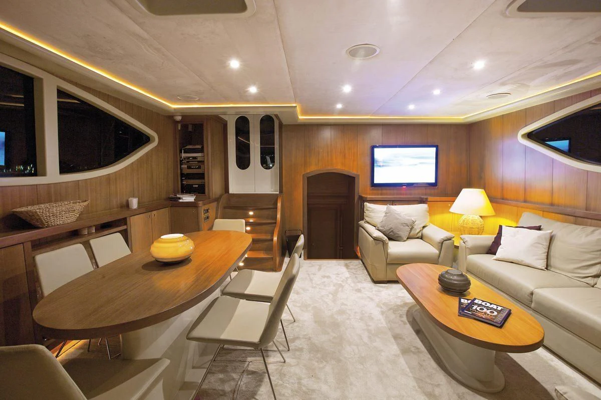 a living room with a table and chairs aboard MISS B Yacht for Sale