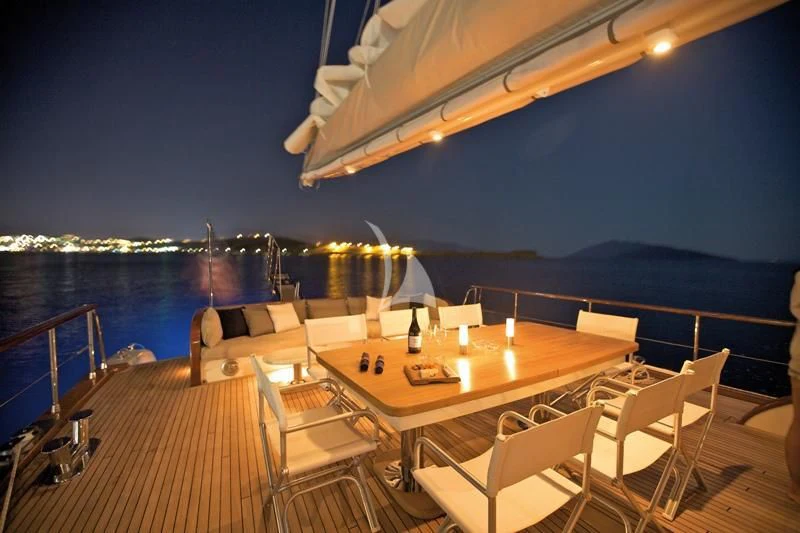 a table with chairs on it aboard MISS B Yacht for Sale