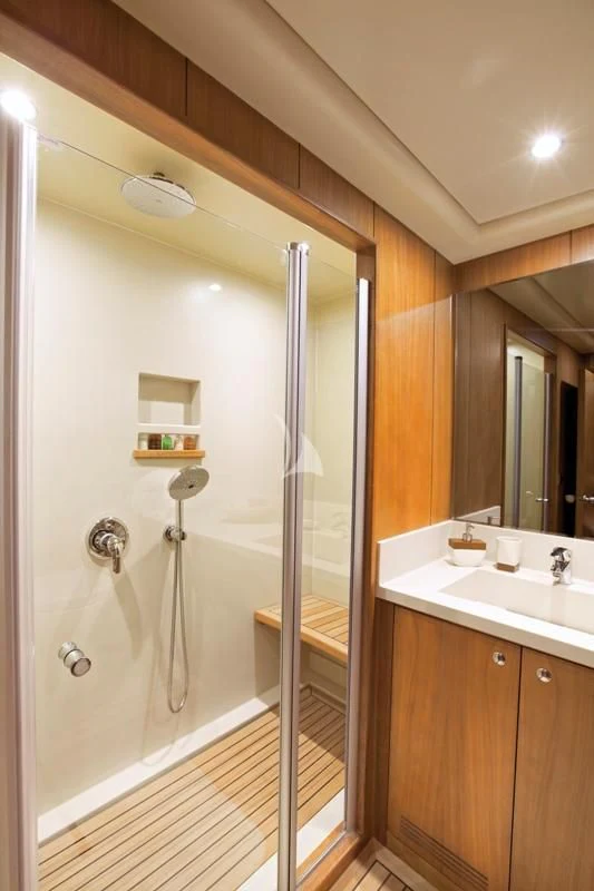 a bathroom with a shower unit and sink aboard MISS B Yacht for Sale