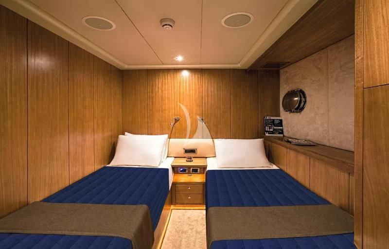 a bedroom with a bed and a sink aboard MISS B Yacht for Sale