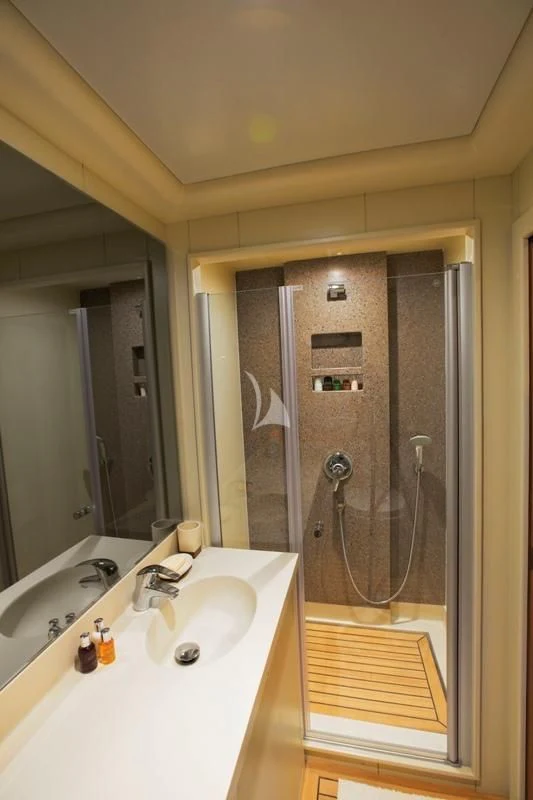 a bathroom with a shower sink and a mirror aboard MISS B Yacht for Sale