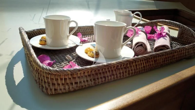 a basket of food and cups aboard MISS B Yacht for Sale