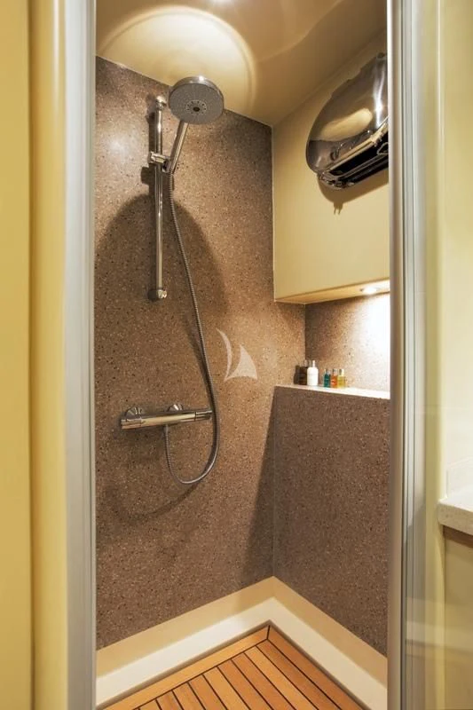 a bathroom with a large shower head aboard MISS B Yacht for Sale