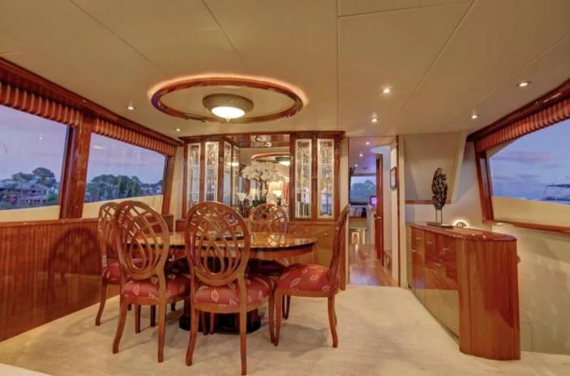 a dining room with a table and chairs aboard NO RULES Yacht for Sale