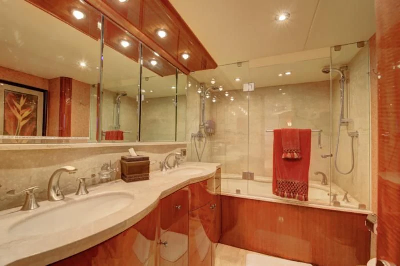 a bathroom with a large mirror aboard NO RULES Yacht for Sale