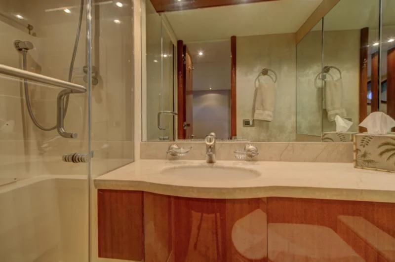 a bathroom with a large mirror aboard NO RULES Yacht for Sale