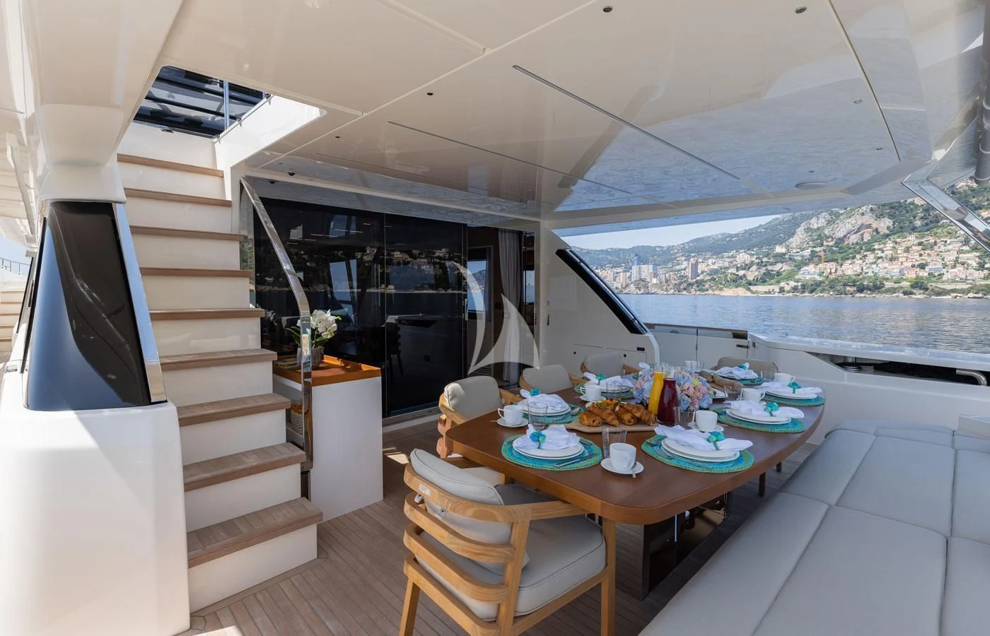a modern looking kitchen with a dining table and a view of the ocean aboard ALEGRIA II Yacht for Sale
