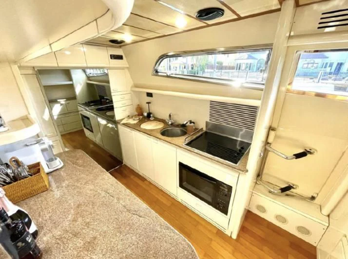 a kitchen with a large window aboard RABBIT Yacht for Sale