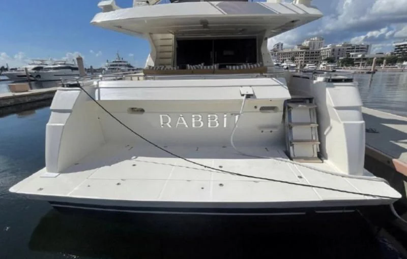 a white yacht in a harbor aboard RABBIT Yacht for Sale