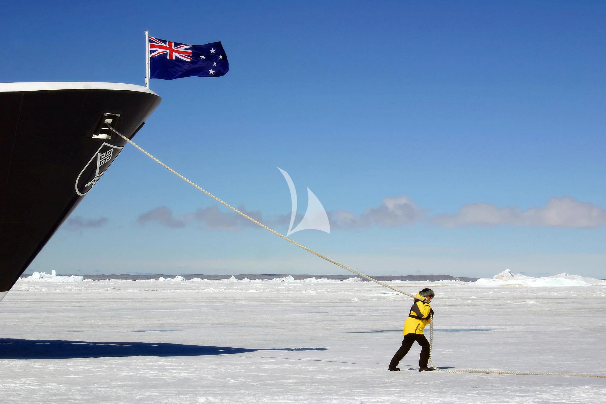 a man flying a flag on a snowy field aboard HANSE EXPLORER Yacht for Sale