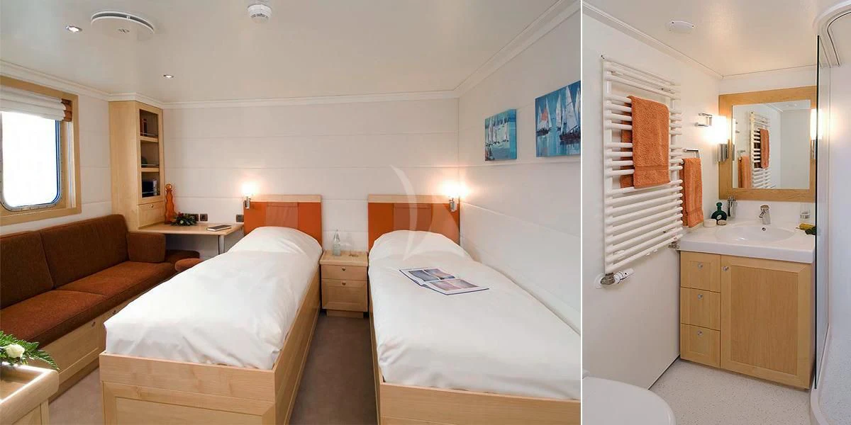 a bedroom with a bed and a couch aboard HANSE EXPLORER Yacht for Sale