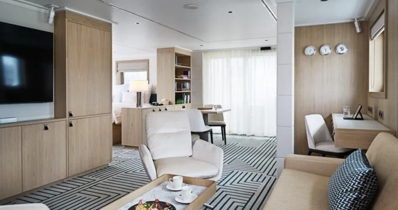 a living room with a couch and a television aboard HANSE EXPLORER Yacht for Sale
