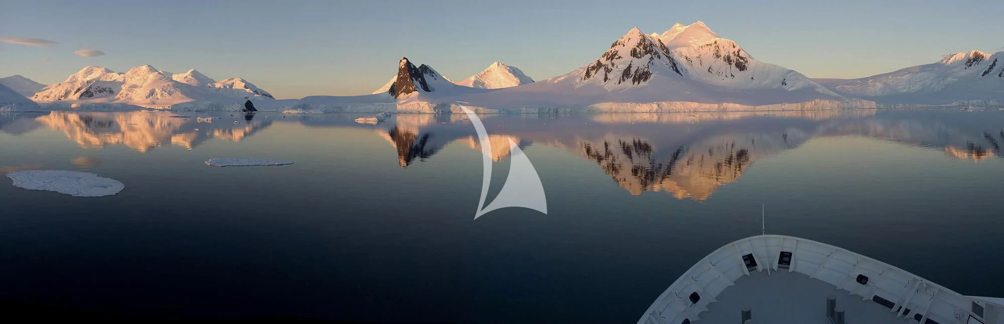 a building with a mountain in the background aboard HANSE EXPLORER Yacht for Sale