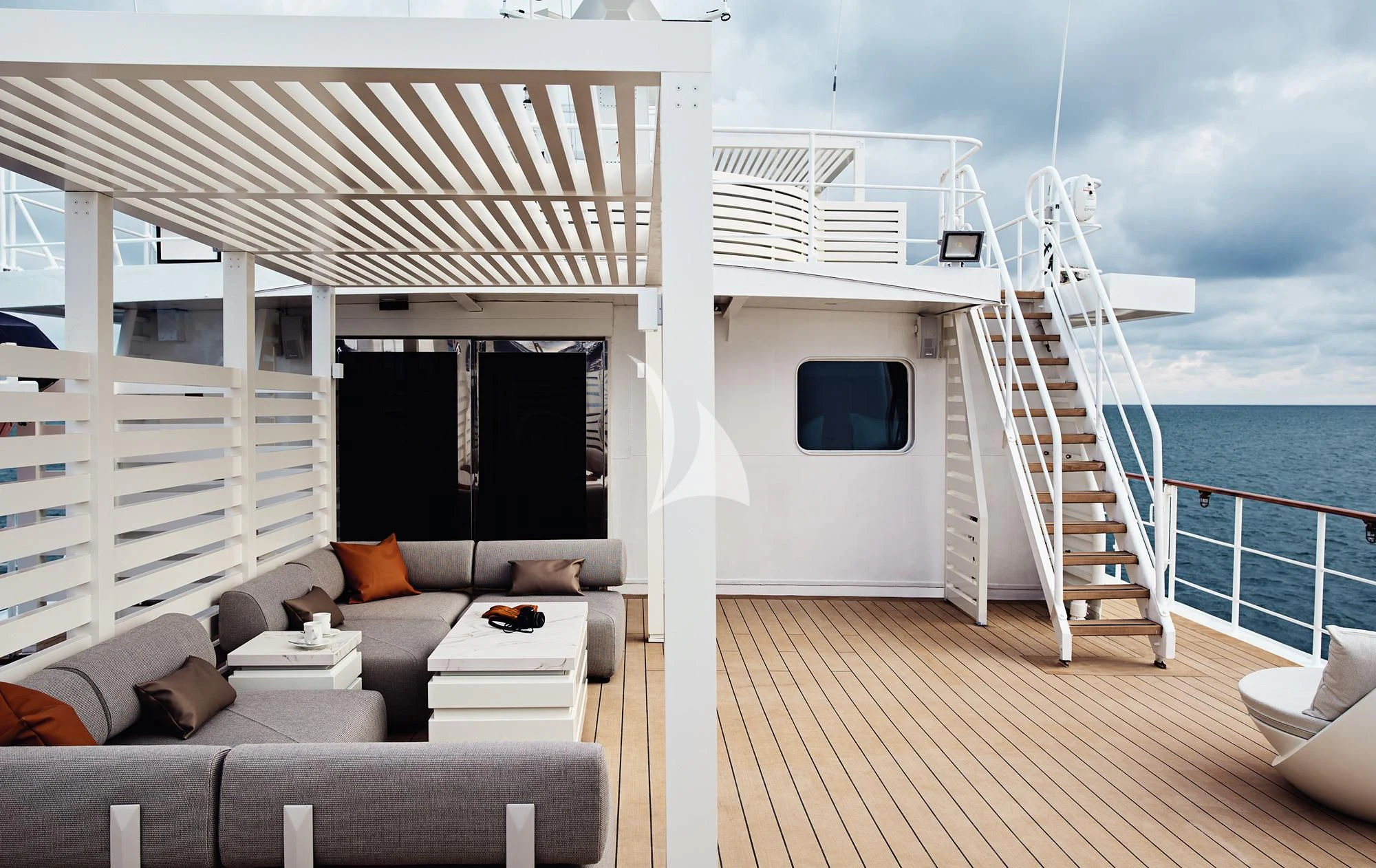 a white house with a deck and a large body of water aboard HANSE EXPLORER Yacht for Sale