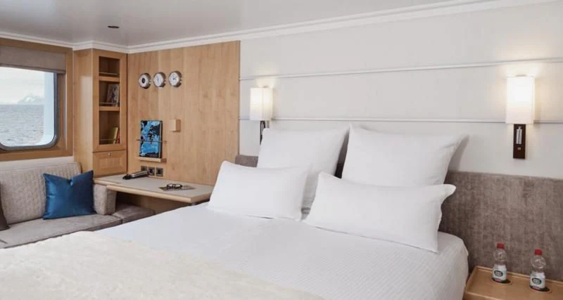 a bed with white pillows aboard HANSE EXPLORER Yacht for Sale