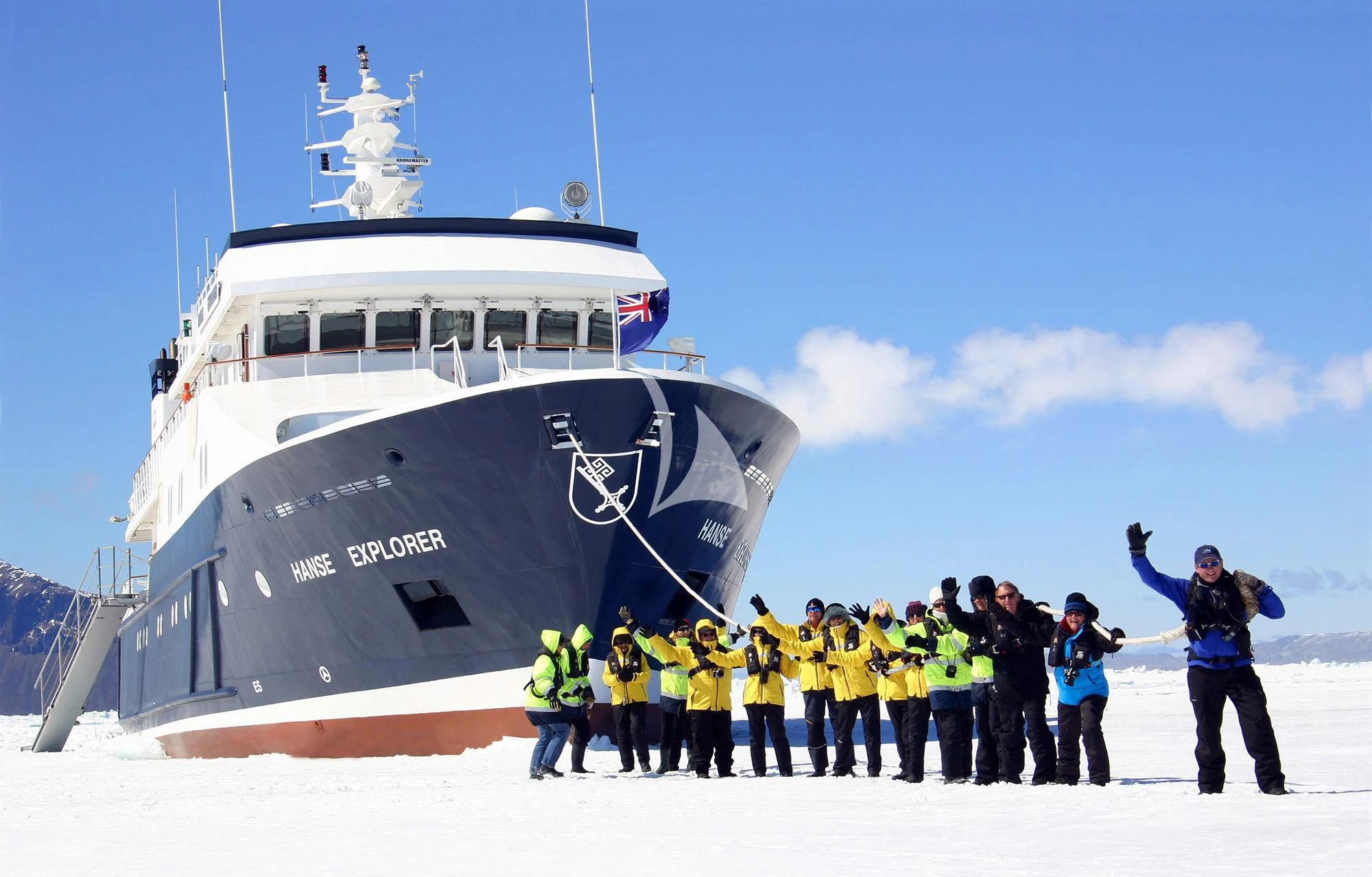 a group of people standing in front of a ship with a group of people on it aboard HANSE EXPLORER Yacht for Sale